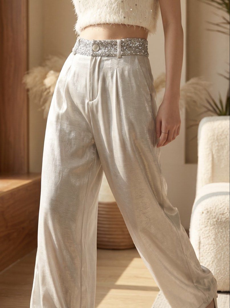 Silver Sequin High Waist Wide Leg Pants (Category: Jeans) located in Taguig. Submitted by kawushii (Listing ID 1470786656, Image 3). Description: - Color: Silver metallic - Style: Wide leg with pleated front - Waistband: Sparkly sequin detail, button closure, and belt loops - Material: Lightweight, flowy, and catches the light nicely - Occasion: Perfect statement piece for parties and evening events - Pairing tip: Looks amazing with simple tops o