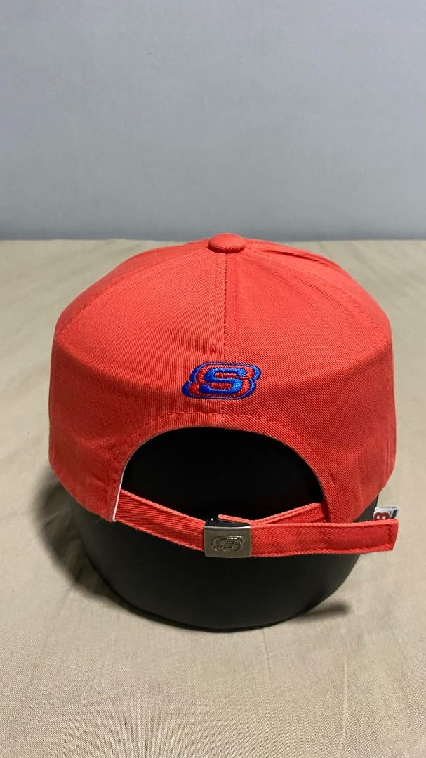 Skechers Red Baseball Cap with Embroidered Logo (Category: Caps & Hats) located in Manila. Submitted by hellmagevtg (Listing ID 1470799557, Image 3). Description: - Brand: Skechers - Color: Bright red with yellow and blue embroidered 'S' logo - Structure: Solid, structured panels that hold their shape well - Brim: Curved brim for sun protection - Fit: Adjustable strap in the back for a custom fit - Condition: Clean stitching throughout, perfect f