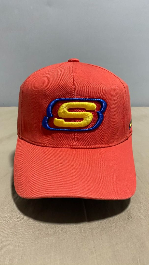 Skechers Red Baseball Cap with Embroidered Logo (Category: Caps & Hats) located in Manila. Submitted by hellmagevtg (Listing ID 1470799557, Image 1). Description: - Brand: Skechers - Color: Bright red with yellow and blue embroidered 'S' logo - Structure: Solid, structured panels that hold their shape well - Brim: Curved brim for sun protection - Fit: Adjustable strap in the back for a custom fit - Condition: Clean stitching throughout, perfect f