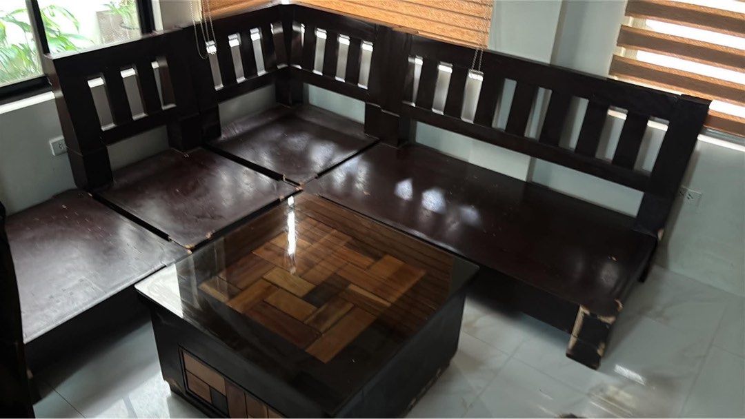 Solid Narra Wooden Sala Set with Center Table - L Shape (Category: Sofas) located in Manila. Submitted by grindyoself (Listing ID 1470769164, Image 1). Description: -Classic and Elegant Design -Durable wooden furniture -Includes Center Table -Pre owned furniture - Classic solid slat-back sofa frame design - Heavy-duty, extremely sturdy build that will last for years Note: Shows minor paint chips and scuffs along the edges from normal use.