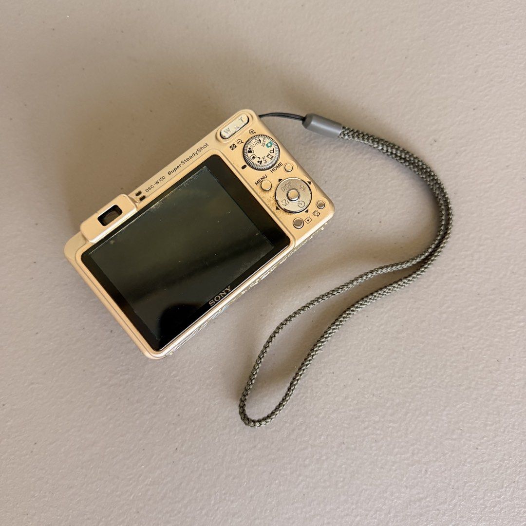 Sony Cybershot DSC-W150 (Category: Cameras) located in Binan City. Submitted by luckythriffs (Listing ID 1470856836, Image 3). Description: Sony Cybershot DSC-W150 (in rare gold color) Price: ₱4,000, Shipped! (FIXED) Bought for ₱5,000 Details: 📸 9/10 body condition ⚡ Working flash (perfect for digicam aesthetic!) 🎀 A TikTok favorite Issue: Minor LCD burn (visible on screen) - Slight blur on the output Inclusions: Battery SD card ➕ Add ₱500 for 