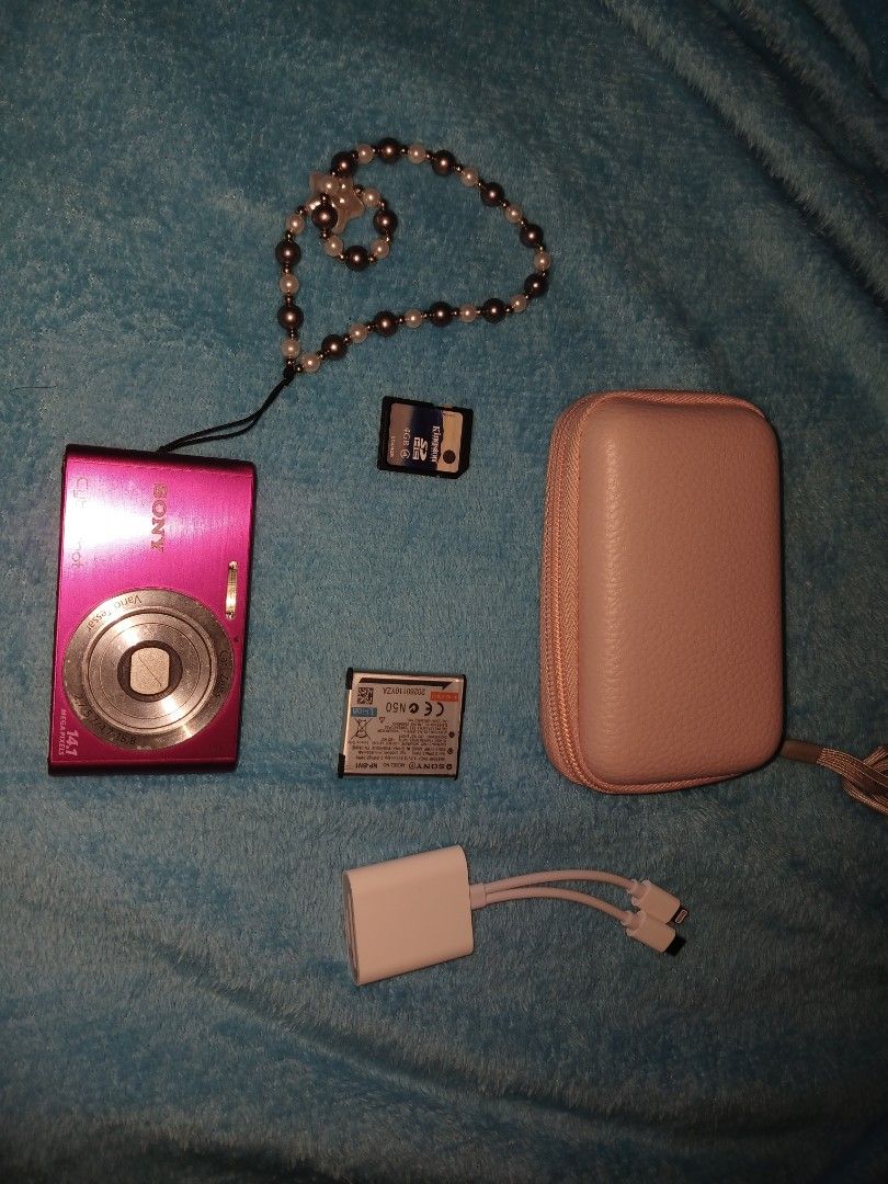 Sony Cyber-shot DSC-W320 14.1 Mega Pixels Pink Digital Camera Bundle (Category: Cameras) located in Kalibo. Submitted by declutter.w.my (Listing ID 1470864597, Image 1). Description: - Model: Pink Sony Cyber-shot DSC-W320 Digital Camera - Resolution: 14.1 Megapixels - Condition: Ready to use, complete bundle - Includes: 4GB Kingston SD card, camera battery, protective pink hard case, pearl-beaded wrist strap, white multi-connector adapter cable, 