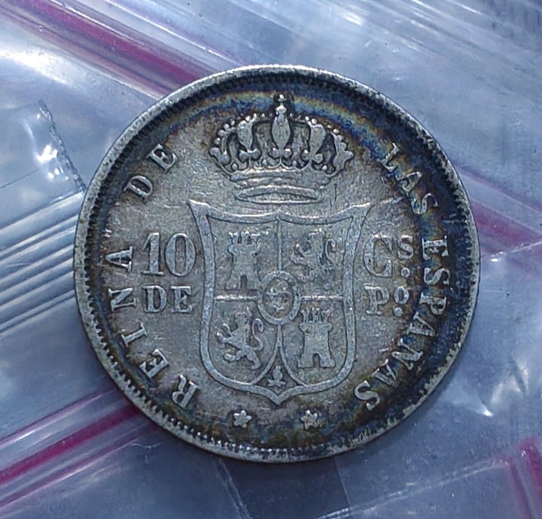 Spain 1868 10 Decimos Silver Coin Isabel II (Category: Currency) located in Taguig. Submitted by ezekiel103 (Listing ID 1470783493, Image 2). Description: - Coin: Spanish 10 Decimos - Year: 1868 - Obverse: Portrait of Queen Isabel II - Reverse: Crowned royal coat of arms - Condition: Moderate wear with nice natural toning and clear details - Perfect addition to any coin or antique collection.