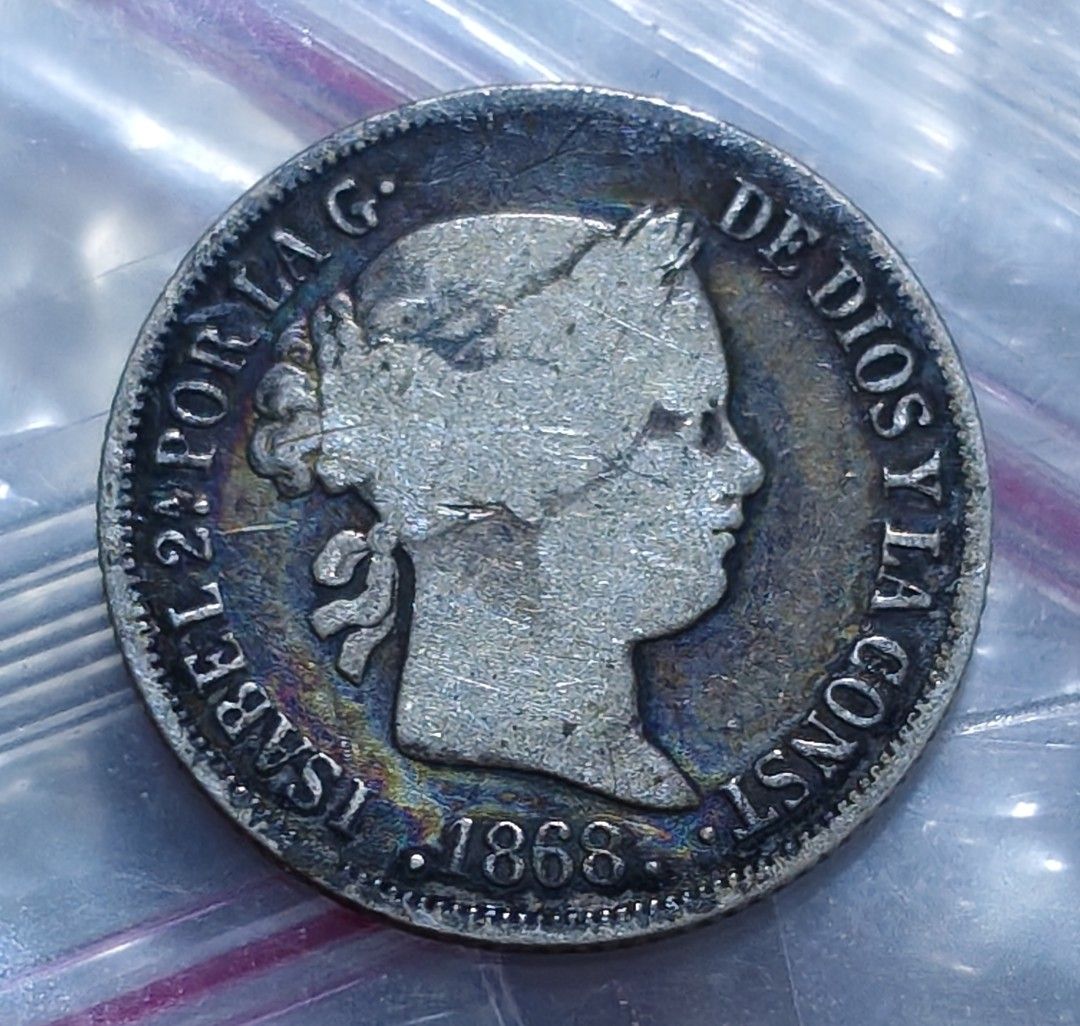 Spain 1868 10 Decimos Silver Coin Isabel II (Category: Currency) located in Taguig. Submitted by ezekiel103 (Listing ID 1470783493, Image 1). Description: - Coin: Spanish 10 Decimos - Year: 1868 - Obverse: Portrait of Queen Isabel II - Reverse: Crowned royal coat of arms - Condition: Moderate wear with nice natural toning and clear details - Perfect addition to any coin or antique collection.