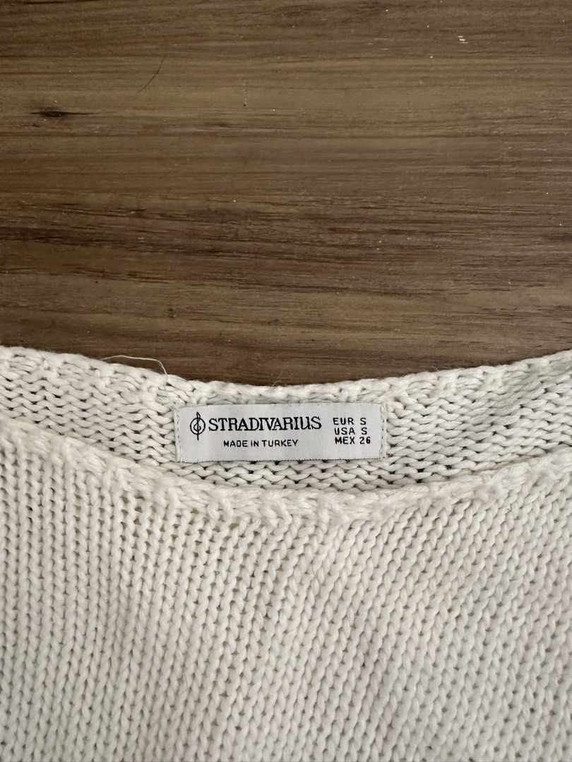 Stradivarius White Knit Cropped Sweater Size S (Category: Longsleeves) located in Paranaque City. Submitted by declutterwyae (Listing ID 1470823876, Image 3). Description: - Brand: Stradivarius - Size: S (Made in Turkey) - Color: Off-white - Design: Loose boat neck, long sleeves, cropped length, ribbed hems - Fabric: Soft knit, very comfy - Condition: Barely worn, excellent shape.