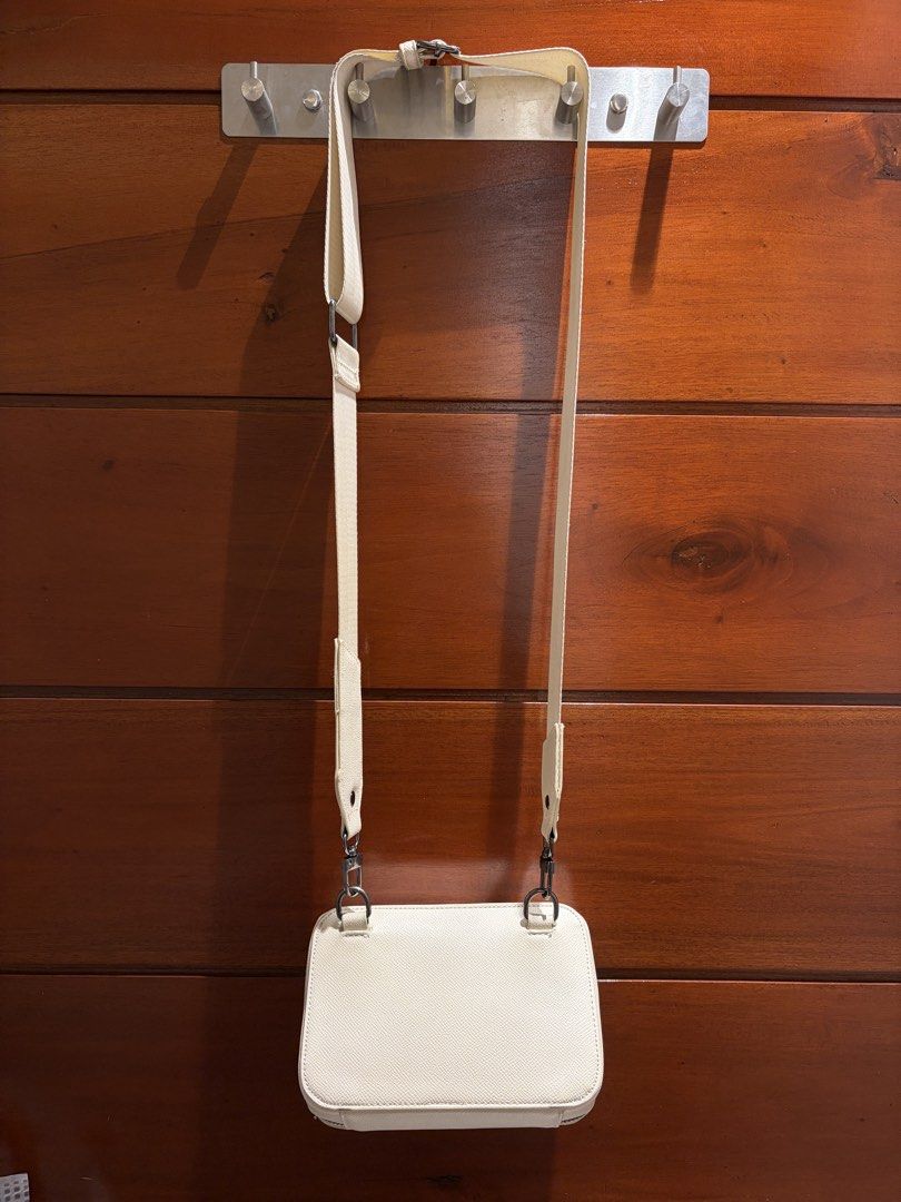 Straightforward DVL Sand Crossbody Bag (Category: Cross-body Bags) located in Cavite. Submitted by eunizcaimol (Listing ID 1470913859, Image 3). Description: - Color: DVL Sand - Material: Daily Vegan leather with black metal-toned hardware - Closure: Double zip opening at the top - Interior: Fabric-lined with a mini pocket - Strap: Adjustable matching shoulder strap with lobster clasps - Condition: Clean interior and exterior, with minor wear on 