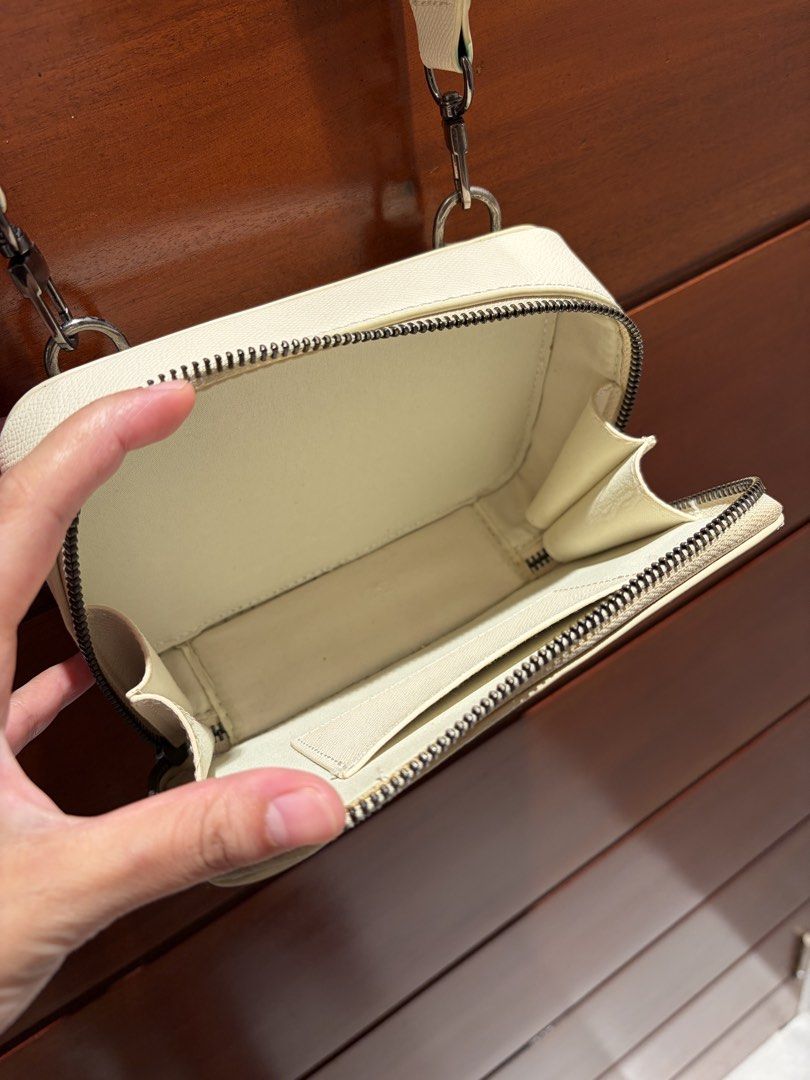 Straightforward DVL Sand Crossbody Bag (Category: Cross-body Bags) located in Cavite. Submitted by eunizcaimol (Listing ID 1470913859, Image 2). Description: - Color: DVL Sand - Material: Daily Vegan leather with black metal-toned hardware - Closure: Double zip opening at the top - Interior: Fabric-lined with a mini pocket - Strap: Adjustable matching shoulder strap with lobster clasps - Condition: Clean interior and exterior, with minor wear on 