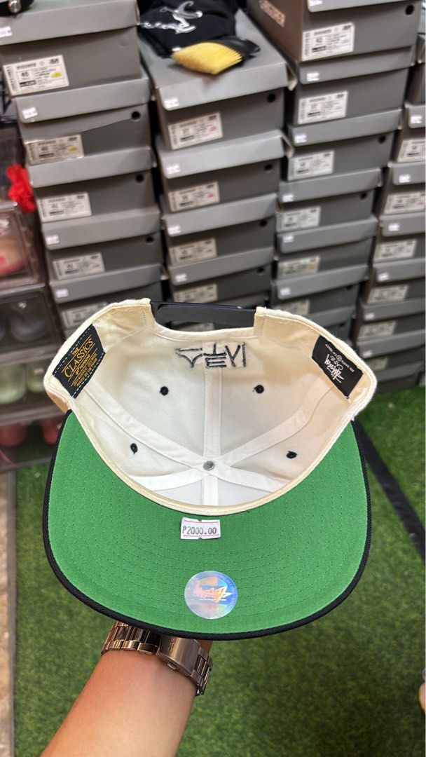Stüssy Snapback Cap White Black (Category: Caps & Hats) located in Manila. Submitted by kobthrift.1223 (Listing ID 1470891646, Image 3). Description: - Brand: Stüssy (Manufactured by Yupoong / The Classics) - Colorway: White crown with black flat brim and green underbrim - Embroidery: Classic Stüssy logo in red/blue on front, unique Korean lettering on the back - Material: 80% acrylic, 20% wool blend for a structured feel - Fit: Adjustable snapba