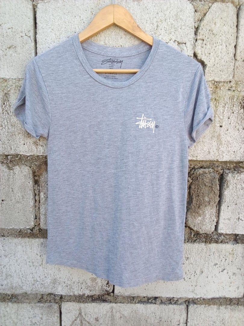 Stussy Gray T-Shirt Small (Category: Tshirts & Polo Shirts ) located in Dinalupihan. Submitted by yanyan.thirft (Listing ID 1470922082, Image 1). Description: - Brand: Stussy - Size: Small - Color: Grey - Design: Small chest logo & large signature back graphic - Details: Short sleeves with rolled cuffs, round neckline - Origin: Made in Mexico - Material: Lightweight, clean fabric - Style: Casual everyday streetwear.