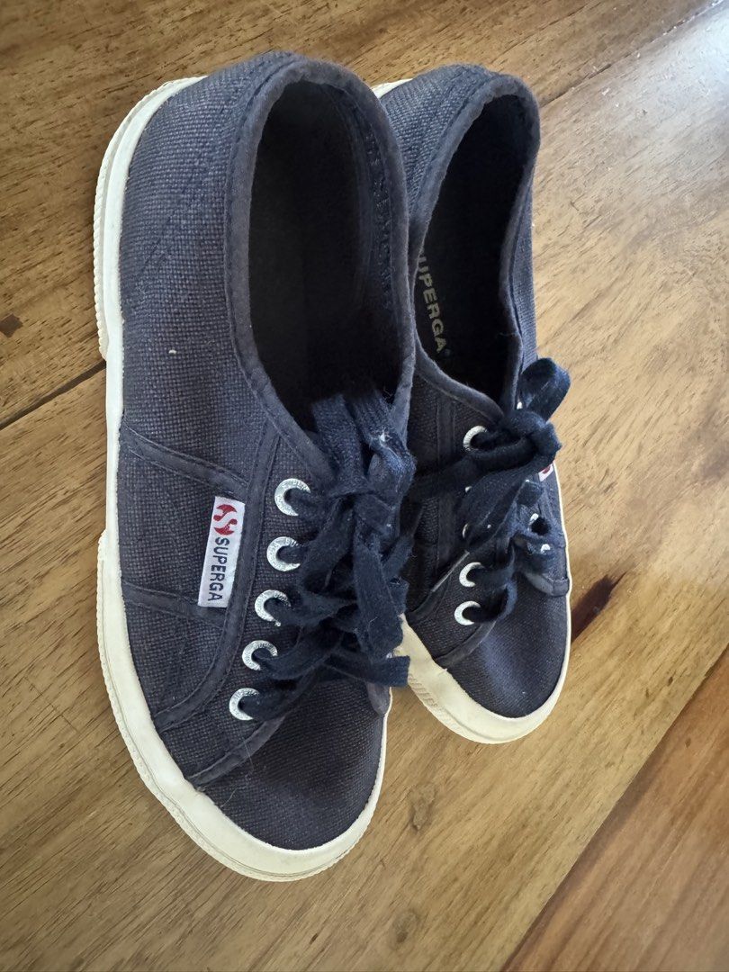 Superga Classic Navy Canvas Sneakers (Category: Sneakers) located in Quezon City. Submitted by tinylee60 (Listing ID 1470751876, Image 2). Description: - Brand: Superga - Color: black - Style: Classic low-top with lace-up closure - Details: Silver-tone eyelets, signature side tag, and branded insole - Soles: White rubber sidewalls with brown textured outsoles - Condition: Clean canvas upper, minimal wear on soles.