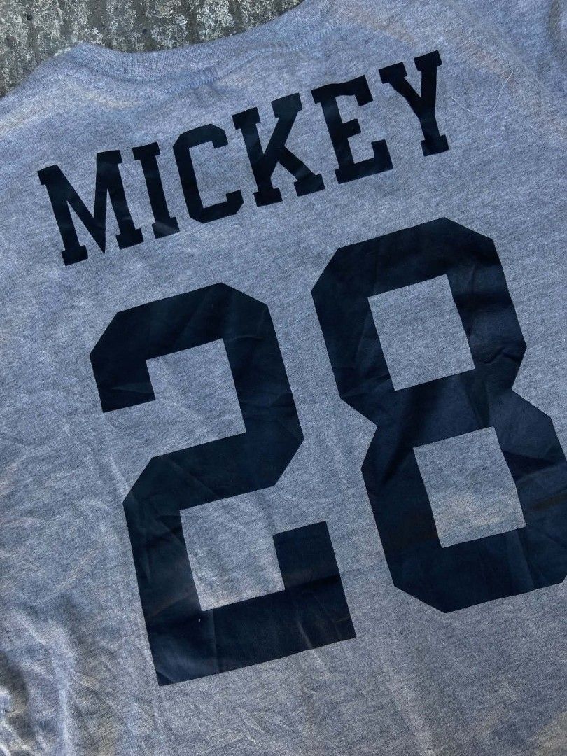 Supreme Mickey Mouse Graphic Tee Gray XL (Category: Tshirts & Polo Shirts ) located in Lianga. Submitted by arwthrifts (Listing ID 1470843952, Image 3). Description: - Authentic Supreme Mickey Mouse graphic tee - Color: Heather Gray - Size: XL - Front features a classic Mickey image on a blue background - Back features "MICKEY" and "28" printed in black - Material: 100% pre-shrunk cotton, made in USA - Condition: Brand new with red swing tag atta