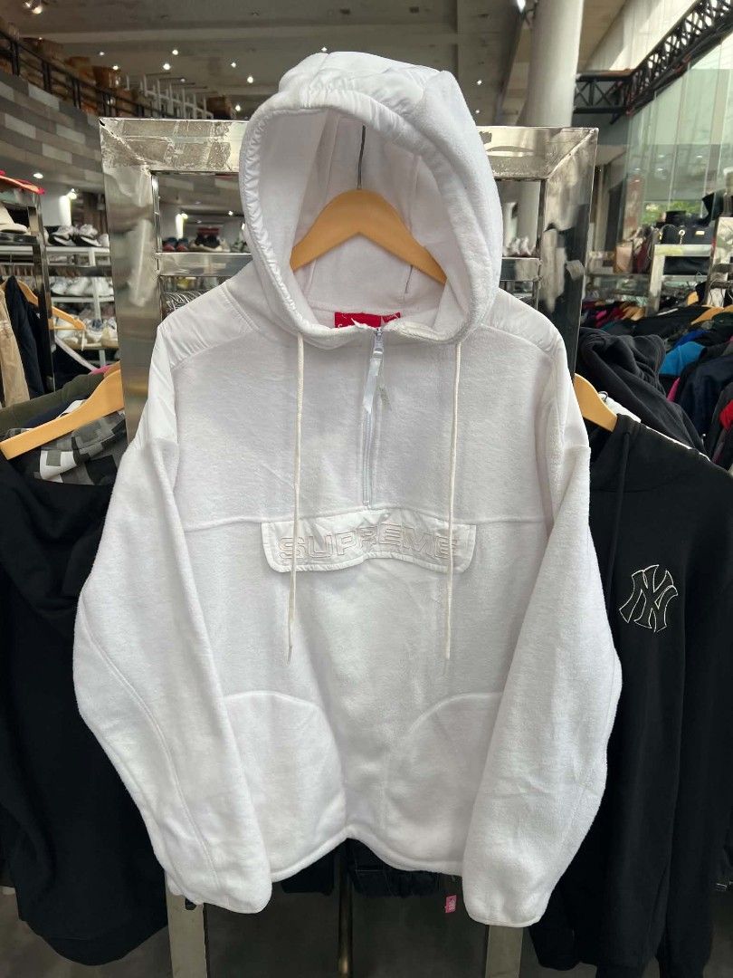 Supreme White Fleece Half-Zip Hoodie (Category: Coats, Jackets and Outerwear) located in Urdaneta. Submitted by jayceegarage (Listing ID 1470880687, Image 1). Description: - Brand: Supreme - Style: White fleece half-zip hoodie - Material: Cozy, warm fleece - Features: Quarter-zip neck, drawstring hood, adjustable fit - Pocket: Front pouch pocket with embroidered Supreme lettering on the flap - Condition: Clean white colorway, tagged inside collar