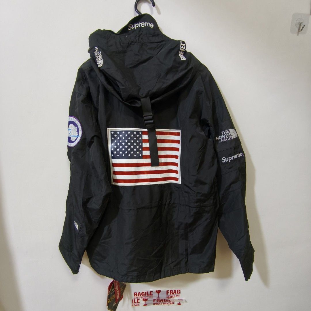 Supreme x The North Face Trans Antarctica Expedition Pullover Black (Category: Coats, Jackets and Outerwear) located in Quezon City. Submitted by inrelationthrift (Listing ID 1470814099, Image 2). Description: - Brand: Supreme x The North Face (Trans Antarctica Expedition Collection) - Color: Black - Material: Gore-Tex (100% waterproof) - Features: USA flag patches on front and back, Antarctica patch on right sleeve, and Supreme branding on hood 
