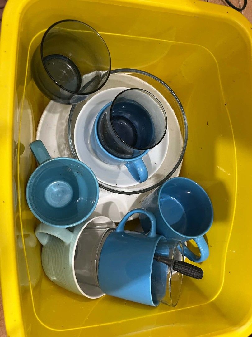 TAKE ALL - Assorted ceramic mugs, glasses, and plates (Category: Coffee & Tea Tableware) located in Paranaque City. Submitted by rjaymagdael (Listing ID 1470774147, Image 1). Description: - Assorted kitchenware bundle perfect for starters - Includes blue mugs, a green ridged mug, smoked glass cups, and white ceramic plates - Comes with a convenient yellow storage container - Mixed styles and colors - Selling everything together as a complete set.