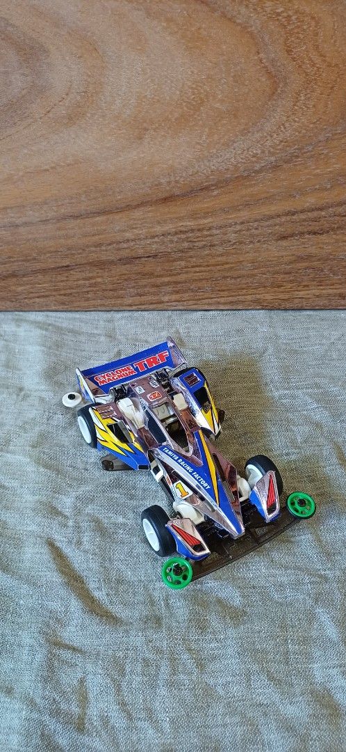 Tamiya Cyclone Magnum TRF Super TZ Chassis (Category: Remote Control Toys) located in Baybay. Submitted by buhatsakahoy (Listing ID 1470794853, Image 3). Description: - Model: Tamiya Cyclone Magnum TRF Mini 4WD car - Chassis: Translucent dark smoke Super TZ - Body: Chrome blue shell with yellow and white racing stripes - Setup: Green rollers on the rear stay and white front bumper - Wheels & Tires: Black slick tires fitted on white wheels - Condi