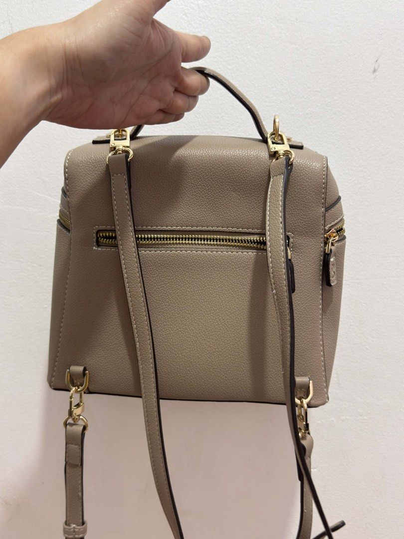 HOLB Taupe Convertible Mini Backpack convertible to sling (Category: Backpacks) located in Manila. Submitted by gmargareth (Listing ID 1470883473, Image 2). Description: - Color/Material: Taupe faux leather with a clean textured finish - Hardware: Premium gold-toned hardware - Straps: Adjustable and removable, plus a convenient top handle - Pockets: Front zipper pocket and secure rear zip pocket - Closure: Top zip closure for the main compartment