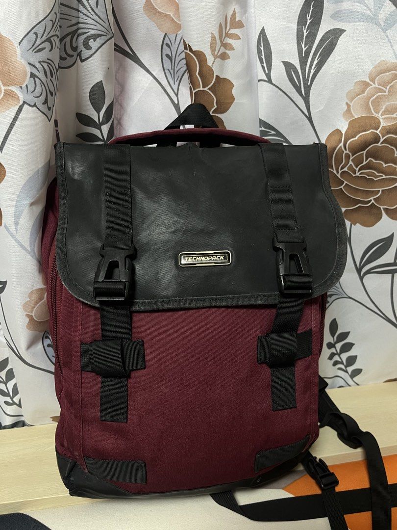 Technopack Maroon and Black Backpack (Category: Backpacks) located in General Trias. Submitted by walterwhiteyo (Listing ID 1470776161, Image 1). Description: - Color: Maroon with black flap cover - Brand: Technopack metal badge - Design: Dual buckle straps and smooth zippers - Comfort: Padded shoulder straps and mesh back panel - Interior: Multiple compartments with branded lining .