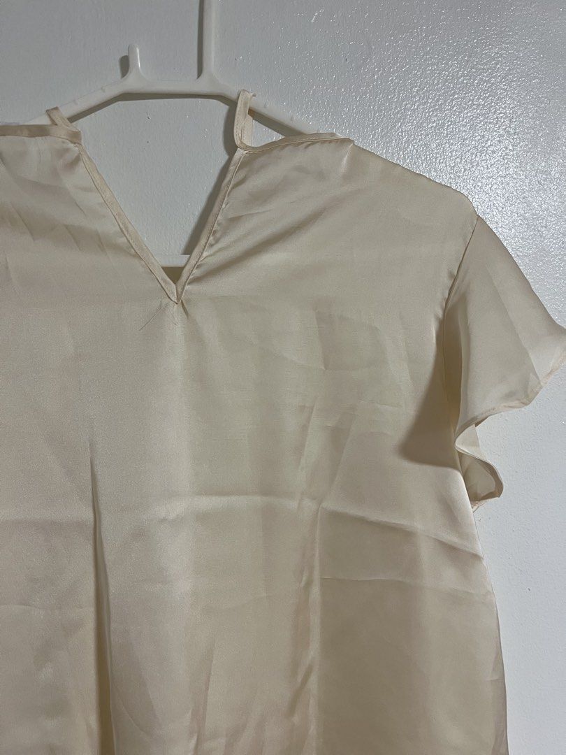Terranova Cream Satin Ruffle Sleeve Blouse (Category: Blouses) located in Cabuyao City. Submitted by rdtrmt (Listing ID 1470744142, Image 2). Description: - Brand: Terranova - Size: L - Material: Smooth satin with a subtle sheen - Design: V-neckline with collar tie strings and short ruffle sleeves - Fit: Relaxed fit through the body - Versatility: Perfect for casual wear or office outfits - Condition: Clean overall, still in good condition.