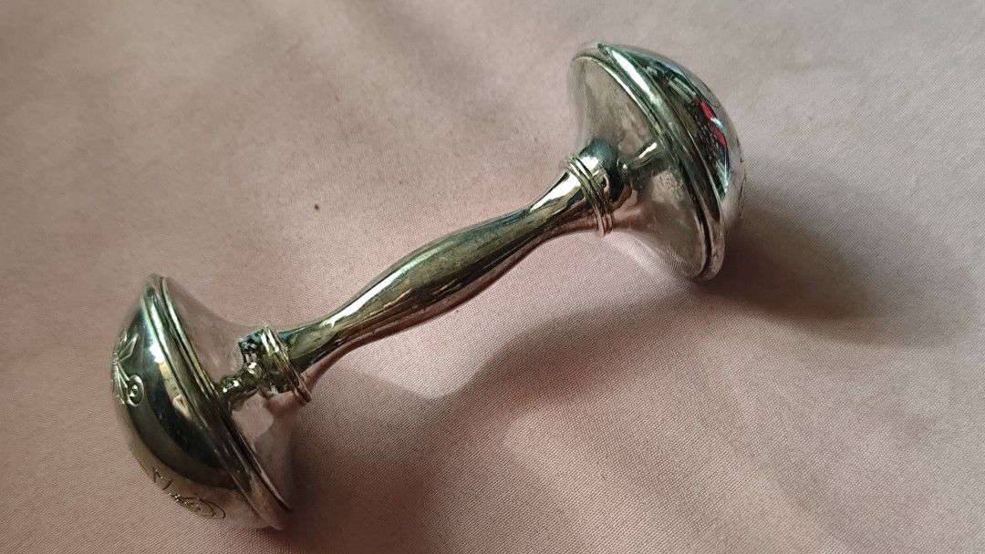The Leonardo Collection Silver Plated Rattle in Box (Category: Vintage Collectibles) located in Quezon City. Submitted by melizaak (Listing ID 1470828353, Image 3). Description: - Brand: The Leonardo Collection - Item: Silver-plated baby rattle in classic dumbbell shape - Design: Cute engraved baby motifs (feeding bottle, bow, booties) - Condition: Brand new, never used, properly stored - Packaging: Comes in original dark blue presentation box wi