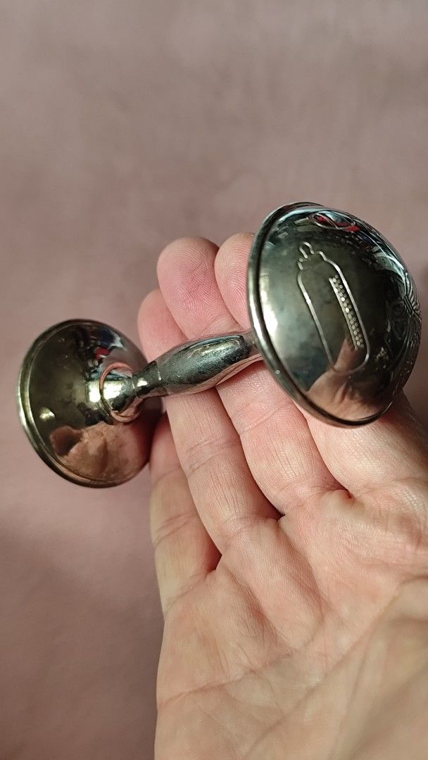 The Leonardo Collection Silver Plated Rattle in Box (Category: Vintage Collectibles) located in Quezon City. Submitted by melizaak (Listing ID 1470828353, Image 2). Description: - Brand: The Leonardo Collection - Item: Silver-plated baby rattle in classic dumbbell shape - Design: Cute engraved baby motifs (feeding bottle, bow, booties) - Condition: Brand new, never used, properly stored - Packaging: Comes in original dark blue presentation box wi