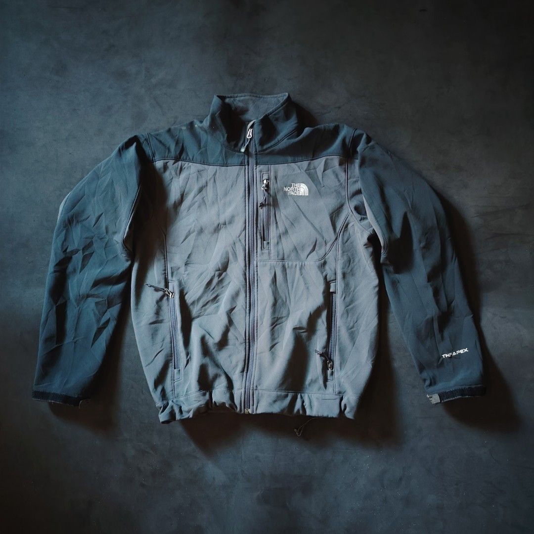 The North Face TNF Apex Softshell Jacket Grey (Category: Coats, Jackets and Outerwear) located in General Santos City (Dadiangas). Submitted by angelodemegilloceballos (Listing ID 1470754738, Image 1). Description: - Brand: The North Face - Style: TNF Apex Softshell Jacket - Color: Dark Grey & Charcoal - Closure: Full zip with stand-up collar - Pockets: 1 chest zip pocket, 2 lower zip hand pockets - Fit & Adjustability: Velcro cuffs and hem drawc