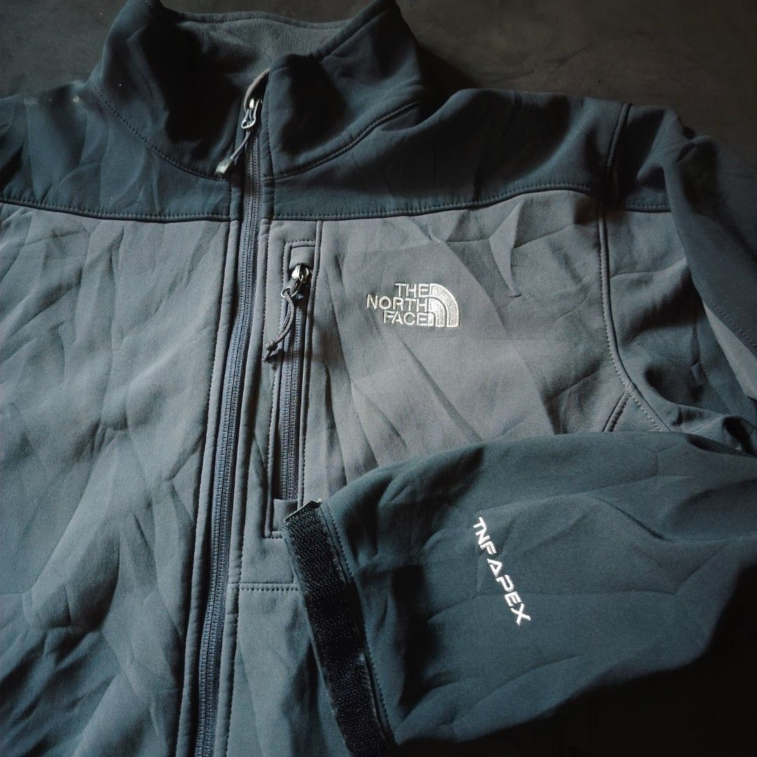 The North Face TNF Apex Softshell Jacket Grey (Category: Coats, Jackets and Outerwear) located in General Santos City (Dadiangas). Submitted by angelodemegilloceballos (Listing ID 1470754738, Image 2). Description: - Brand: The North Face - Style: TNF Apex Softshell Jacket - Color: Dark Grey & Charcoal - Closure: Full zip with stand-up collar - Pockets: 1 chest zip pocket, 2 lower zip hand pockets - Fit & Adjustability: Velcro cuffs and hem drawc