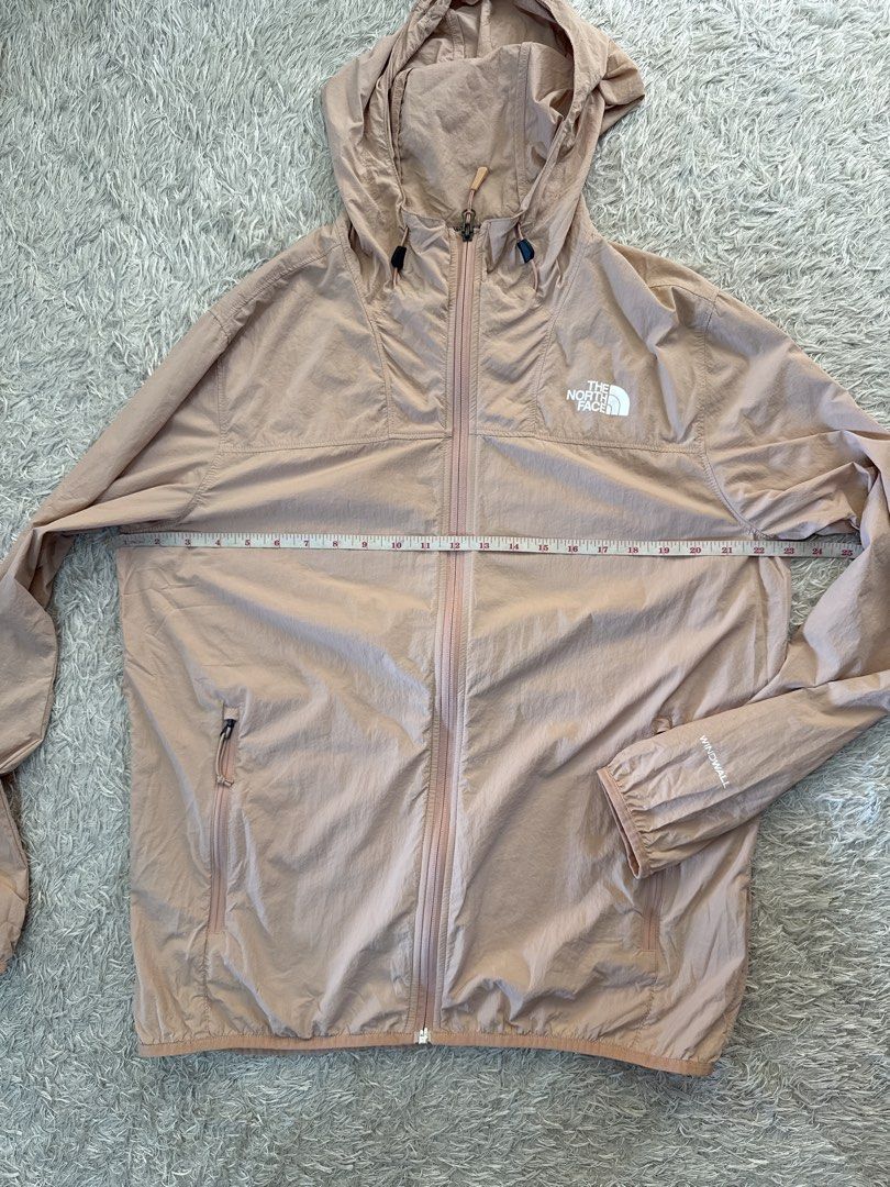 The North Face WindWall Pink Windbreaker Jacket (Category: Coats, Jackets and Outerwear) located in Quezon City. Submitted by dropdeadprices (Listing ID 1470785804, Image 2). Description: - Brand: The North Face - Style: Unisex WindWall Hooded Jacket - Color: Peach Pink - Features: Full zip closure, secure zipped hand pockets, adjustable hood drawstrings, WindWall wind-blocking technology - Material: 100% nylon shell - Size on Tag: US Men's M/L /
