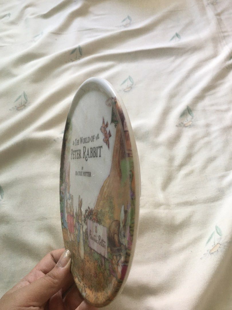 The World of Peter Rabbit Vintage Ceramic Plate Decor (Category: Dinnerware & Cutlery) located in Cabuyao City. Submitted by 4everblooms (Listing ID 1470783965, Image 2). Description: - Smooth glazed white finish with a raised circular base and embossed logo stamp - Ideal as a decorative display piece or for a kid's room.