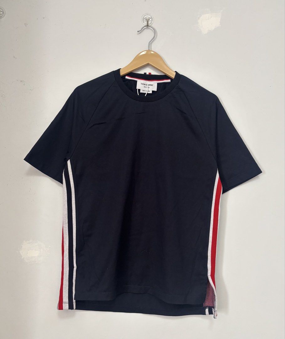 Thom Browne Navy T-shirt Size 2 (Category: Tshirts & Polo Shirts ) located in Bacolod City. Submitted by gilbertgon94115 (Listing ID 1470789880, Image 1). Description: - Brand: Thom Browne - Condition: Brand new with tags attached - Color: Dark Navy Blue - Size: 2 (Medium) - Dimes 19.5 x 25.5 / 27 - Material: 100% premium cotton - Design Details: Signature tricolor (red, white, blue) side panels with mesh gusset vents - Neckline: Classic crewneck