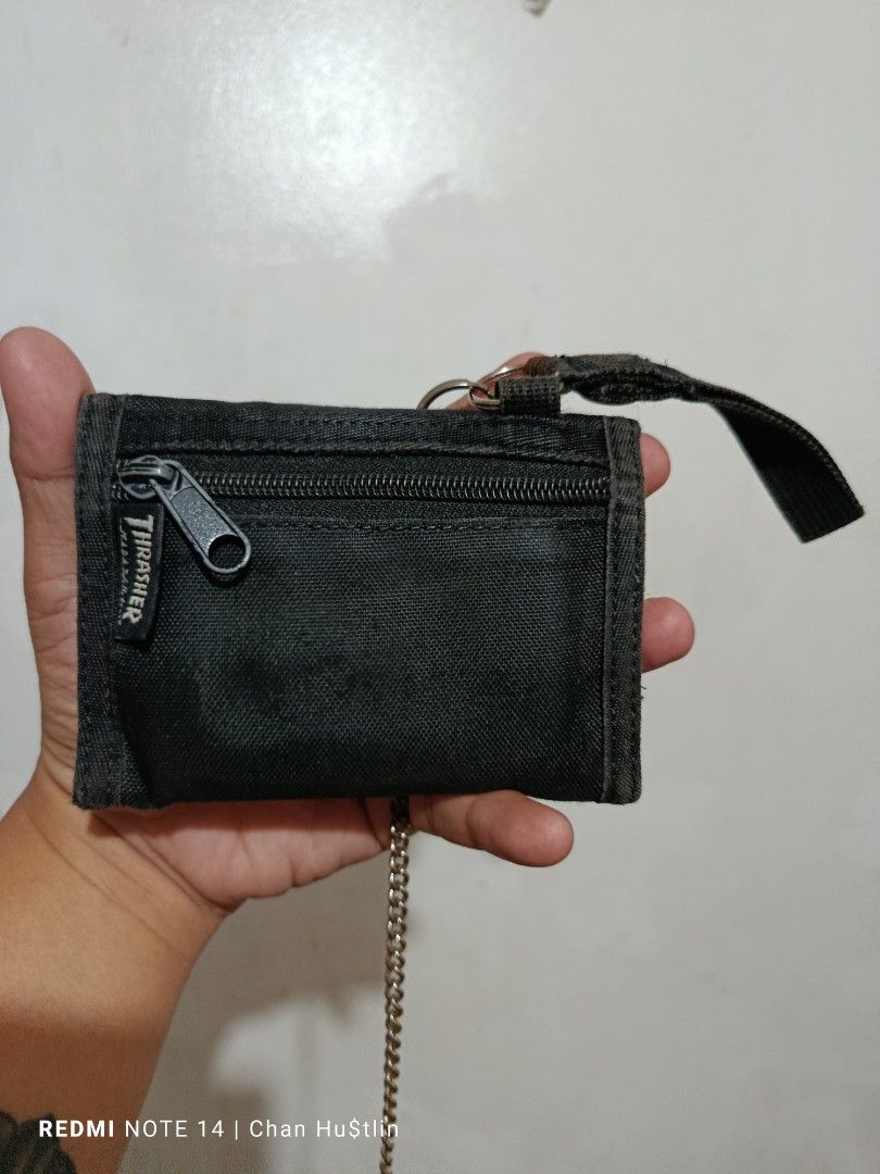 Thrasher Black Tri-fold Vintage Wallet with Chain (Category: Wallets & Card Holders) located in Calamba. Submitted by chanmagpantay (Listing ID 1470754196, Image 2). Description: - Brand: Thrasher - Color/Material: Black canvas - Type: Tri-fold wallet - Storage: Outer zipper pocket, multiple interior card slots, and cash compartments - Extras: Attached metal chain and loop strap included - Condition: Brand new / Excellent quality skate accessory.