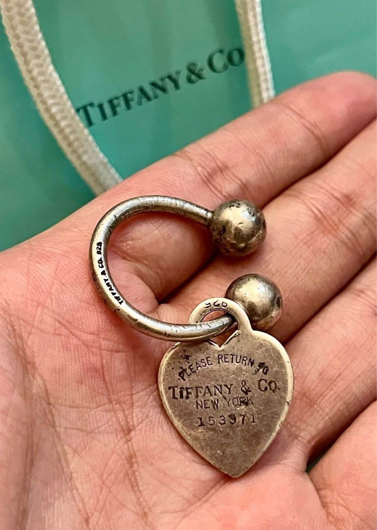 silver Tiffany & Co. "Return to Tiffany" horseshoe key ring (Category: Luxury Accessories) located in Alfonso. Submitted by jbcamet (Listing ID 1470827045, Image 3). Description: - 100% Authentic Tiffany & Co. Return to Tiffany heart tag key ring - Material: Sterling silver (hallmarked 925 on tag and ring) - Features iconic 'Please Return to Tiffany & Co. New York 153971' engraving - Condition: Good, shows natural tarnishing from storage which ca