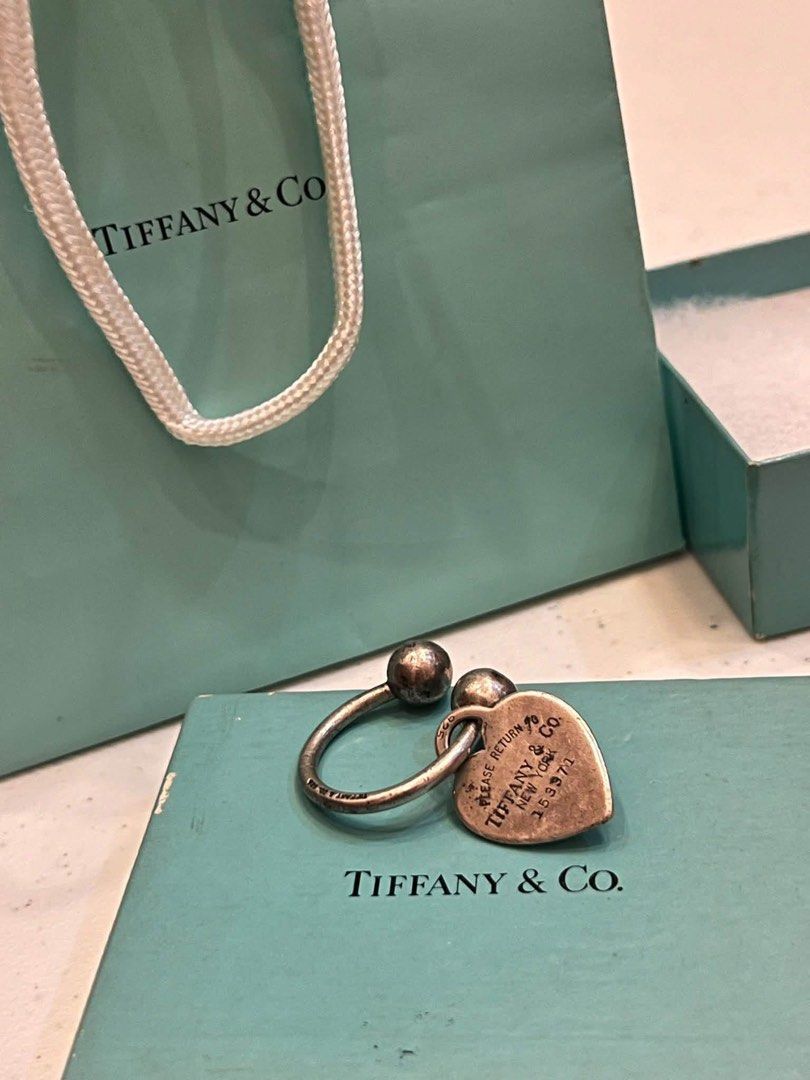 silver Tiffany & Co. "Return to Tiffany" horseshoe key ring (Category: Luxury Accessories) located in Alfonso. Submitted by jbcamet (Listing ID 1470827045, Image 2). Description: - 100% Authentic Tiffany & Co. Return to Tiffany heart tag key ring - Material: Sterling silver (hallmarked 925 on tag and ring) - Features iconic 'Please Return to Tiffany & Co. New York 153971' engraving - Condition: Good, shows natural tarnishing from storage which ca
