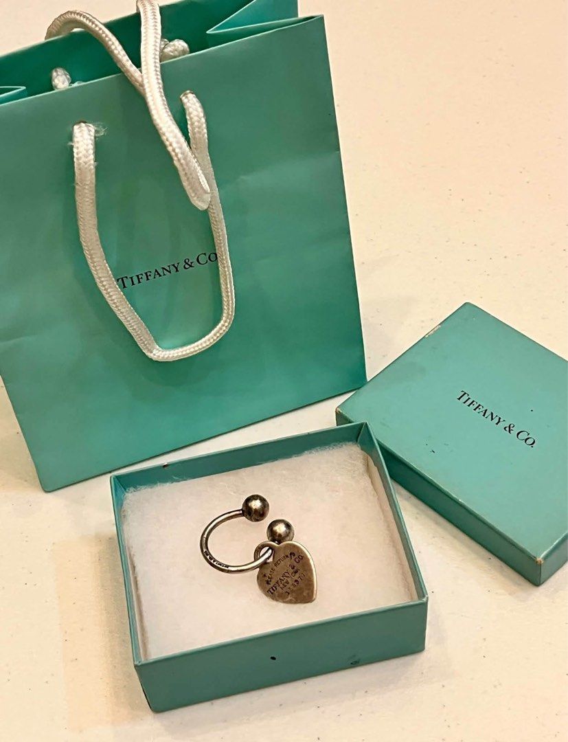 silver Tiffany & Co. "Return to Tiffany" horseshoe key ring (Category: Luxury Accessories) located in Alfonso. Submitted by jbcamet (Listing ID 1470827045, Image 1). Description: - 100% Authentic Tiffany & Co. Return to Tiffany heart tag key ring - Material: Sterling silver (hallmarked 925 on tag and ring) - Features iconic 'Please Return to Tiffany & Co. New York 153971' engraving - Condition: Good, shows natural tarnishing from storage which ca