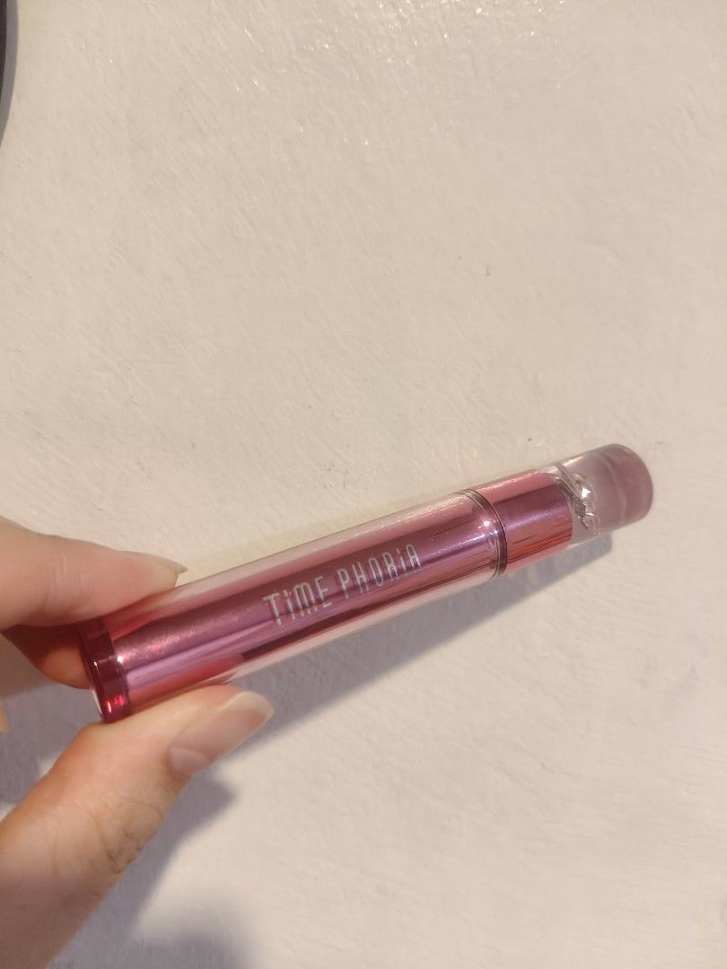 Time Phoria Altera Blurring Lip Tint 006 Wisp (Category: Makeup) located in Davao. Submitted by yvanaavik_sulit (Listing ID 1470891670, Image 1). Description: - Brand: Time Phoria Altera Blurring Lip Tint - Shade: 006 Wisp (Versatile, great daily pink) - Condition: Swatched once / barely used (99% product left) - Size: 4g / 0.14 oz - Packaging: Metallic pink with clear cap and decorative spiral - Applicator: Hygienic doe-foot applicator.