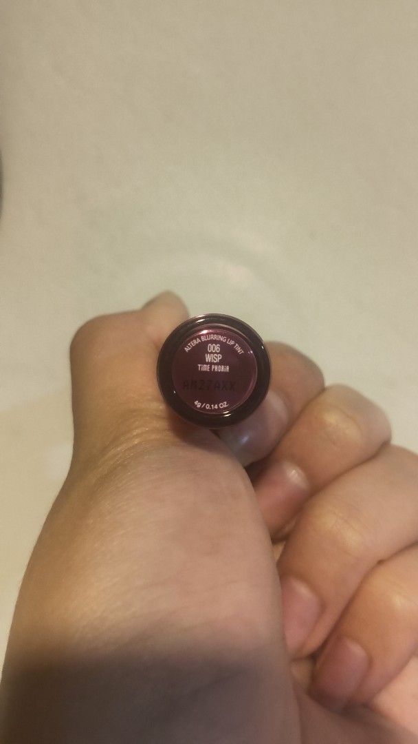 Time Phoria Altera Blurring Lip Tint 006 Wisp (Category: Makeup) located in Davao. Submitted by yvanaavik_sulit (Listing ID 1470891670, Image 3). Description: - Brand: Time Phoria Altera Blurring Lip Tint - Shade: 006 Wisp (Versatile, great daily pink) - Condition: Swatched once / barely used (99% product left) - Size: 4g / 0.14 oz - Packaging: Metallic pink with clear cap and decorative spiral - Applicator: Hygienic doe-foot applicator.