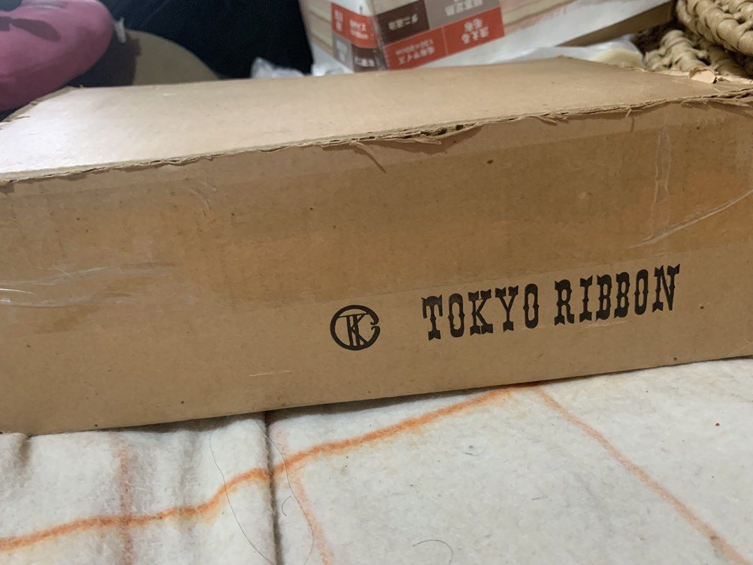 Tokyo Ribbon Assorted Colors Set with Box (Category: Craft Supplies & Tools) located in Malolos. Submitted by rubyche88 (Listing ID 1470826389, Image 1). Description: - Authentic Tokyo Ribbon rolls in a bulk box - Assorted vibrant colors: purple, pink, white, green, yellow, and orange - Includes various spool widths for different uses - Ideal for craft projects, gift wrapping, floral arrangements, and party decor - Most rolls still have plenty of