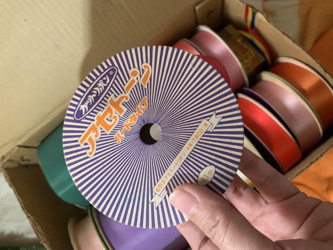 Tokyo Ribbon Assorted Colors Set with Box (Category: Craft Supplies & Tools) located in Malolos. Submitted by rubyche88 (Listing ID 1470826389, Image 2). Description: - Authentic Tokyo Ribbon rolls in a bulk box - Assorted vibrant colors: purple, pink, white, green, yellow, and orange - Includes various spool widths for different uses - Ideal for craft projects, gift wrapping, floral arrangements, and party decor - Most rolls still have plenty of