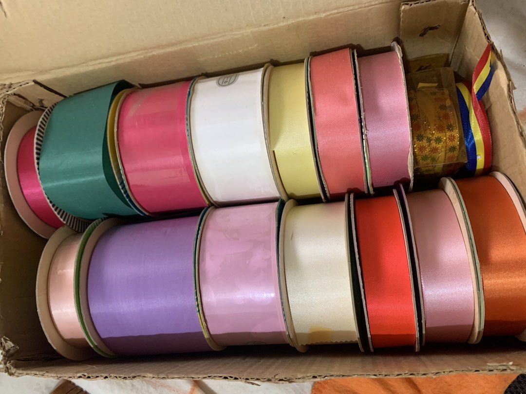Tokyo Ribbon Assorted Colors Set with Box (Category: Craft Supplies & Tools) located in Malolos. Submitted by rubyche88 (Listing ID 1470826389, Image 3). Description: - Authentic Tokyo Ribbon rolls in a bulk box - Assorted vibrant colors: purple, pink, white, green, yellow, and orange - Includes various spool widths for different uses - Ideal for craft projects, gift wrapping, floral arrangements, and party decor - Most rolls still have plenty of