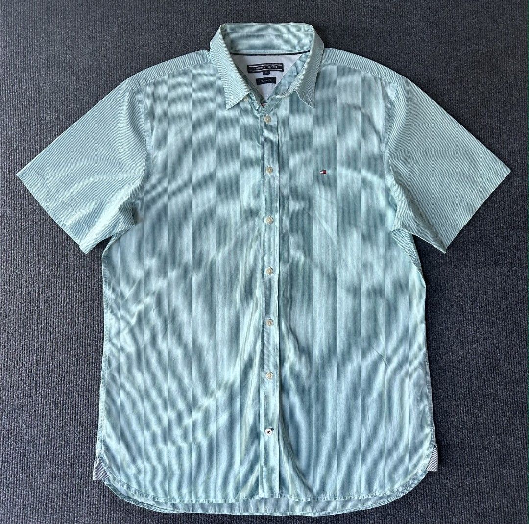 Tommy Hilfiger (Category: Tshirts & Polo Shirts ) located in Imus. Submitted by alecsssss (Listing ID 1470768266, Image 1). Description: - Brand: Tommy Hilfiger - Style: Mint green & white striped short sleeve shirt - Fit: Custom fit, button-down front with collar - Details: Small embroidered logo on chest - Size: Medium - Condition: Excellent for casual or smart-casual wear - Mode of Payment: GCash or bank transfer - Shipping: J&T Express or Sam