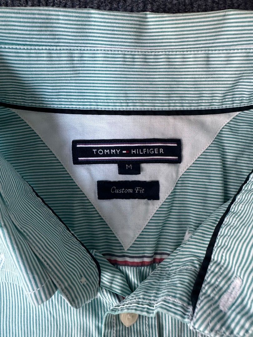 Tommy Hilfiger (Category: Tshirts & Polo Shirts ) located in Imus. Submitted by alecsssss (Listing ID 1470768266, Image 2). Description: - Brand: Tommy Hilfiger - Style: Mint green & white striped short sleeve shirt - Fit: Custom fit, button-down front with collar - Details: Small embroidered logo on chest - Size: Medium - Condition: Excellent for casual or smart-casual wear - Mode of Payment: GCash or bank transfer - Shipping: J&T Express or Sam