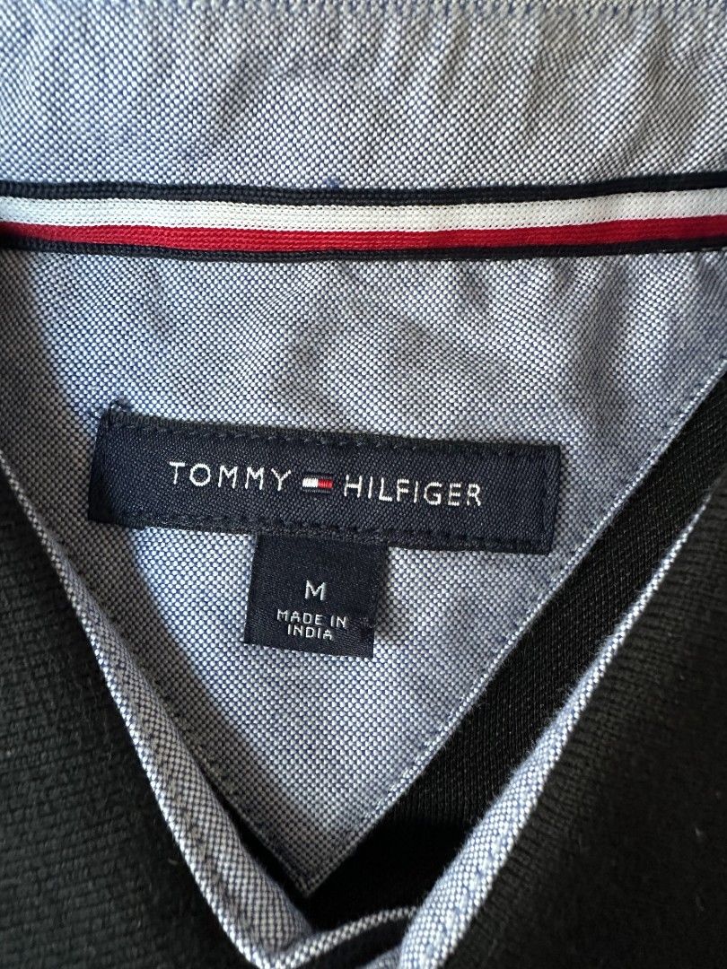Tommy Hilfiger (Category: Tshirts & Polo Shirts ) located in Imus. Submitted by alecsssss (Listing ID 1470770408, Image 2). Description: - Brand: Tommy Hilfiger - Color: Black - Size: Medium - Details: Classic collar with red, white, and blue tipping; two-button placket; small embroidered logo on left chest - Style: Short sleeve, versatile for casual outfits - Condition: 7/10 - May punit sa isang manggas.