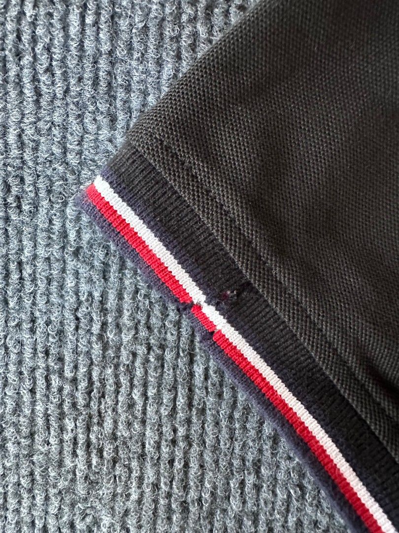 Tommy Hilfiger (Category: Tshirts & Polo Shirts ) located in Imus. Submitted by alecsssss (Listing ID 1470770408, Image 3). Description: - Brand: Tommy Hilfiger - Color: Black - Size: Medium - Details: Classic collar with red, white, and blue tipping; two-button placket; small embroidered logo on left chest - Style: Short sleeve, versatile for casual outfits - Condition: 7/10 - May punit sa isang manggas.