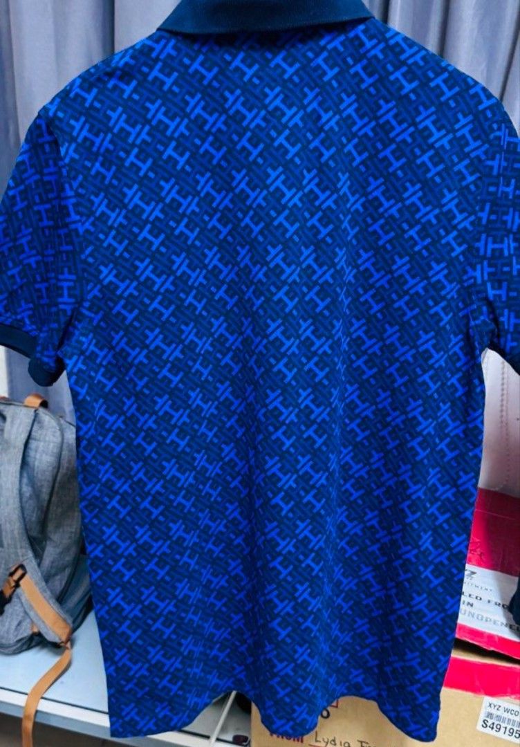 Tommy Hilfiger Blue Patterned Polo Shirt (Category: Formal Shirts) located in Quezon City. Submitted by Chess (Listing ID 1470778875, Image 2). Description: Tommy Hilfiger polo shirt features a blue pattern design. ✨ It has a classic polo collar and short sleeves. ✨ The shirt is made in Vietnam and is composed of 97% cotton and 3% elastane. ✨ The shirt has a button closure at the neckline. 1,800 shipped‼️.