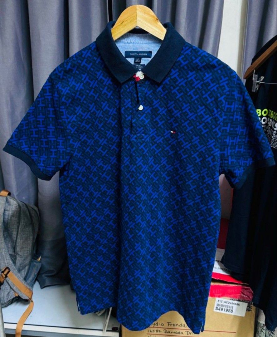 Tommy Hilfiger Blue Patterned Polo Shirt (Category: Formal Shirts) located in Quezon City. Submitted by Chess (Listing ID 1470778875, Image 1). Description: Tommy Hilfiger polo shirt features a blue pattern design. ✨ It has a classic polo collar and short sleeves. ✨ The shirt is made in Vietnam and is composed of 97% cotton and 3% elastane. ✨ The shirt has a button closure at the neckline. 1,800 shipped‼️.