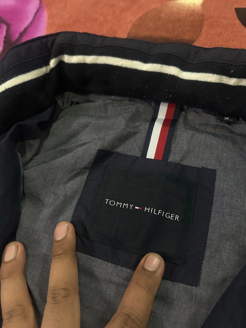 TOMMY HILFIGER PACKABLE HOOD WINDBREAKER JACKET (Category: Coats, Jackets and Outerwear) located in Dasmarinas. Submitted by dnnr3rdyyyyy (Listing ID 1470821499, Image 2). Description: Dimensions 23 Width 27 Length Size medium on tags Good as new condition 9.5/10 color rate Minimal Issues All goods Zipper & Buttons Authentic/Legit Navy Blue Color .