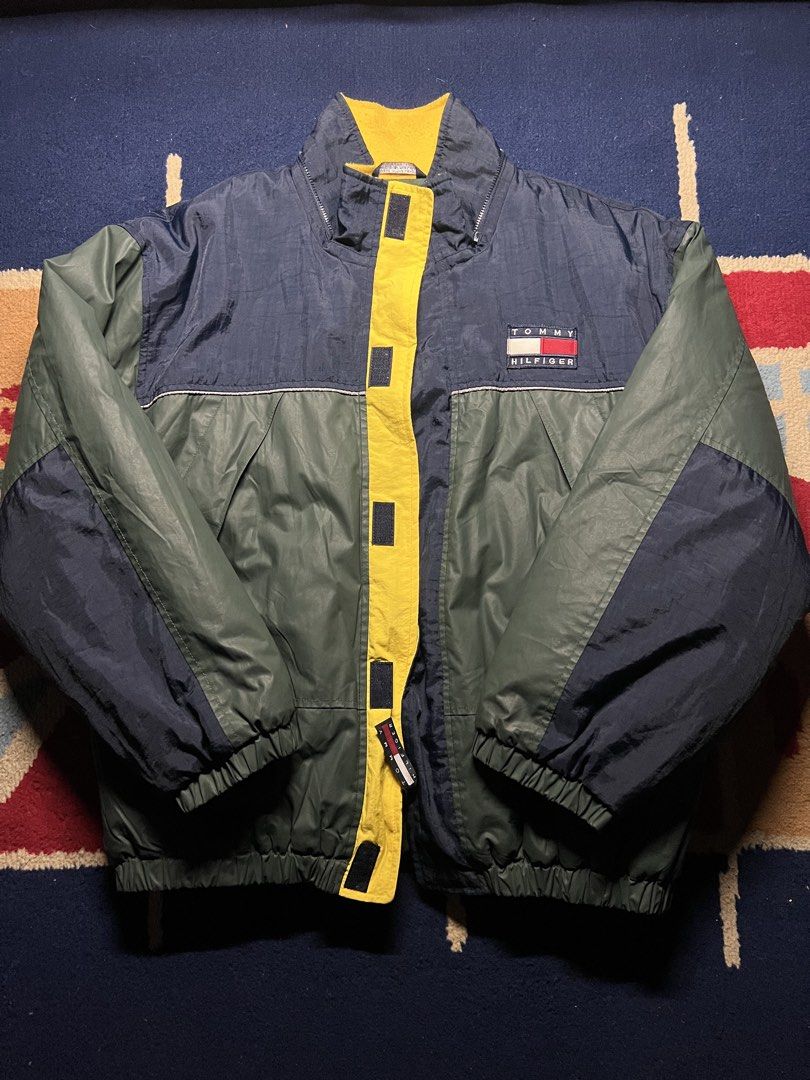 Tommy Hilfiger Vintage 90s Puffer Jacket (Category: Coats, Jackets and Outerwear) located in Pasig City. Submitted by downlowtooslow (Listing ID 1470877813, Image 1). Description: Vintage Tommy Hilfiger Colorblock PufferJacket 22 width 26 length - Classic Tommy Hilfiger embroidered chest logo - Full-zip design with a bold yellow front closure.