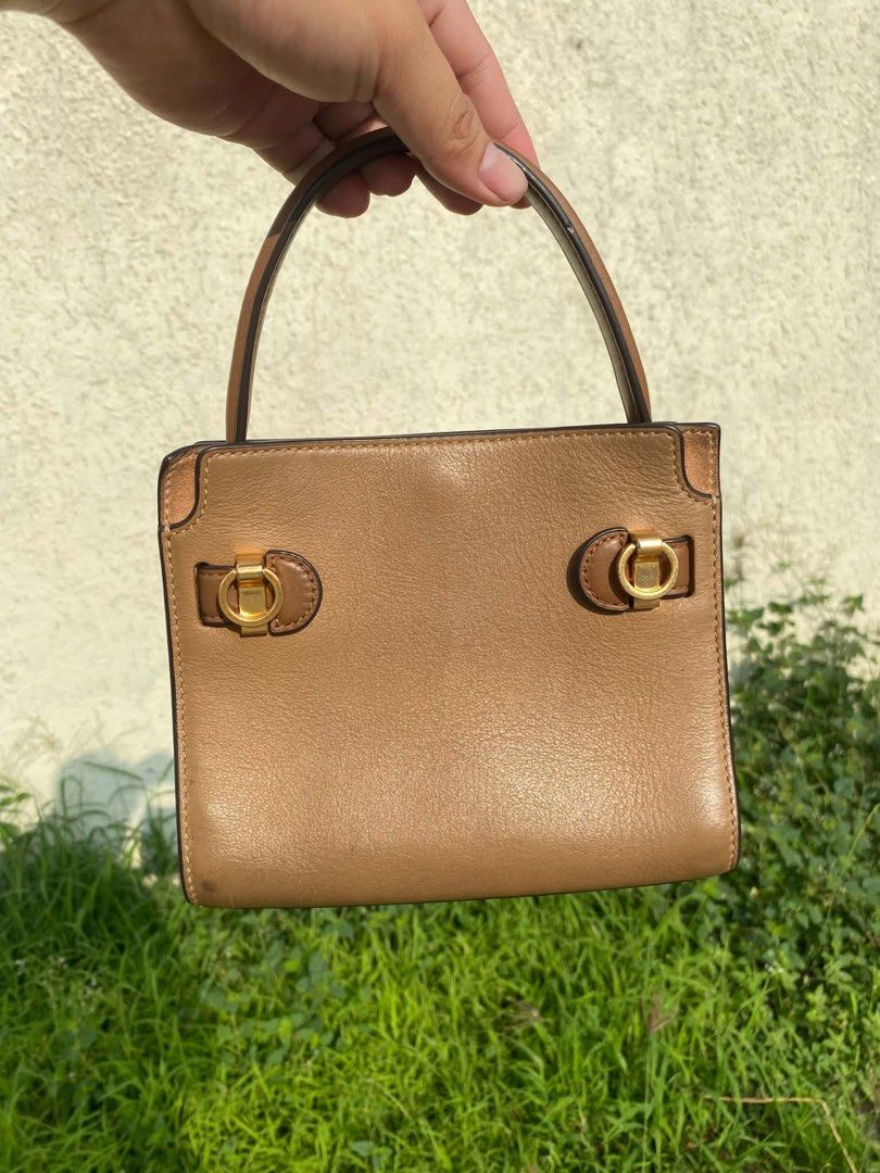 Tory Burch Petite Lee Radziwill Double Bag Aged Tan (Category: Luxury Bags & Wallets) located in Manila. Submitted by sharmatine97049 (Listing ID 1470875706, Image 3). Description: Tory Burch Petite Lee Radziwill Double Bag in aged tan leather. Structured shape with signature lock hardware and top handle. Includes detachable shoulder strap. Gold-tone hardware details throughout. Interior features multiple compartments and card slots. Clean lining