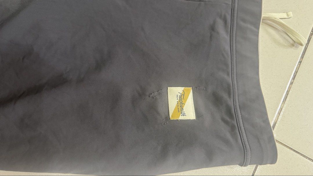 Tracksmith Half Tights (Category: Shorts) located in Caloocan City. Submitted by kennethsy1993 (Listing ID 1470782382, Image 2). Description: - Brand: Tracksmith New England - Color: Dark grey - Design: Woven patch logo on front hem and reflective rabbit logo near side pocket - Fit: Elastic waistband with adjustable drawstring - Storage: Multiple rear pockets for essentials - Condition: Excellent running shorts ready for use.