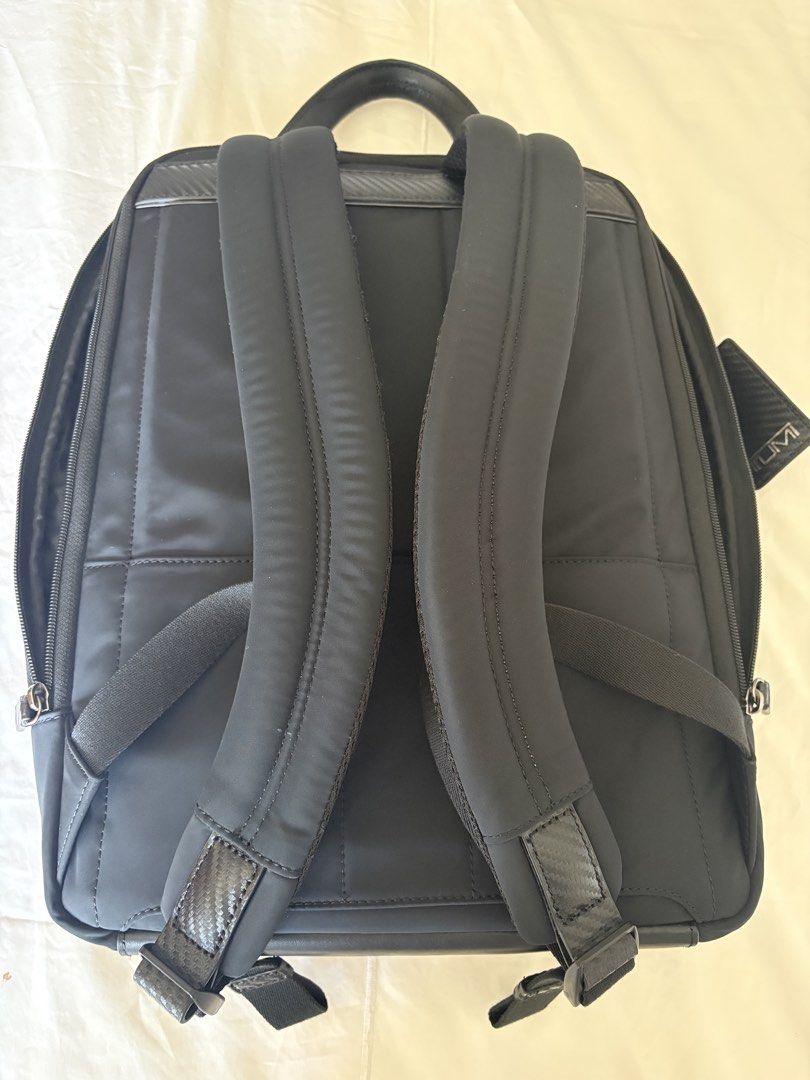 TUMI Black Backpack with Carbon Fiber Accents (Category: Backpacks) located in Taguig. Submitted by gurgeh50 (Listing ID 1470757727, Image 3). Description: - Authentic black TUMI backpack with sleek carbon fiber patterned trim - Durable nylon construction ideal for daily commute, work, or travel - Spacious main compartment with a padded laptop sleeve and secure zipper pocket - Front organizer section with dedicated slots for cards, pens, and esse