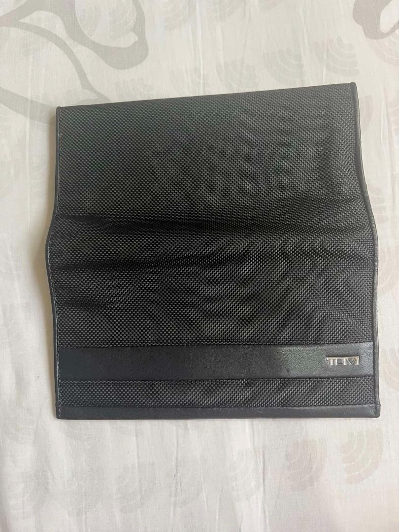 TUMI Black Long Wallet (Category: Wallets & Card holders) located in Manila. Submitted by pengsalvador (Listing ID 1470831706, Image 2). Description: - Brand: TUMI - Material: Durable ballistic nylon with premium leather trim - Color: Classic Black - Exterior: Front flap with iconic metal TUMI logo plate - Interior: Multiple card slots, spacious bill compartments, and a secure zippered pocket - Condition: Clean interior lining and well-maintained